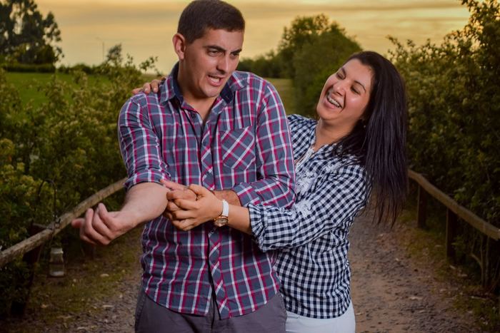 Pareja abrazada y riendo al atardecer