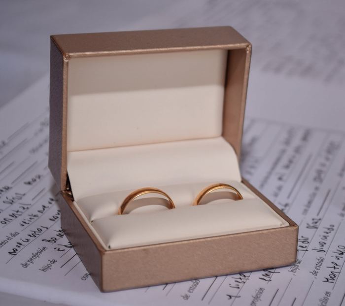 Anillos de casamiento en su estuche sobre la libreta