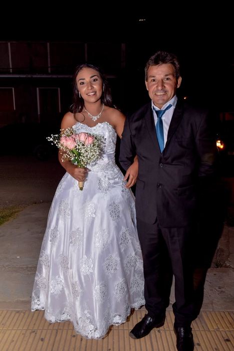 Novia del brazo del padrino en la noche