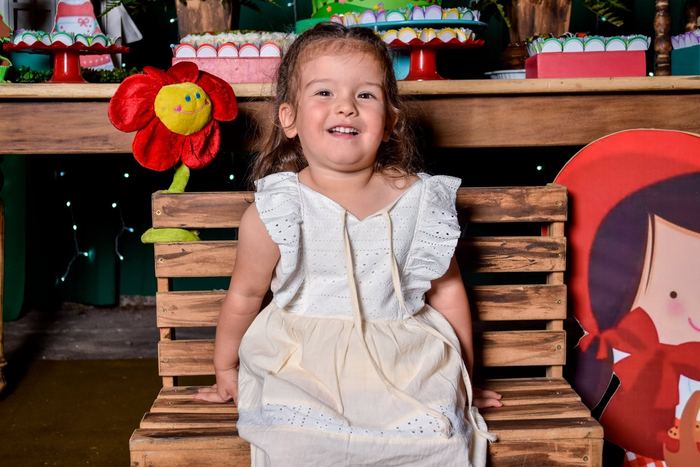 Nena sonriendo en la ambientación de Caperucita